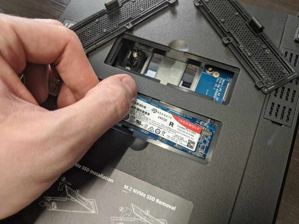 Человек устанавливает SSD Seagate IronWolf в Synology NAS, демонстрируя установку M.2 NVMe SSD.