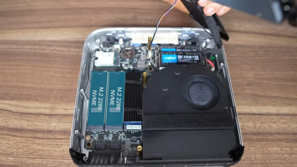 Открытый мини-ПК Minisforum AI X1 Pro, показывающий внутренние компоненты, включая SSD M.2 2280 NVMe и охлаждающий вентилятор.